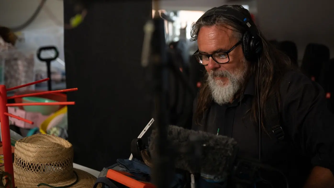 Location sound recordist working on production