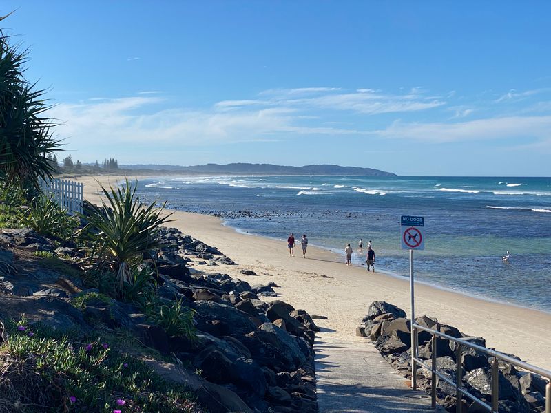 People walking beside the beach at Lennox Head