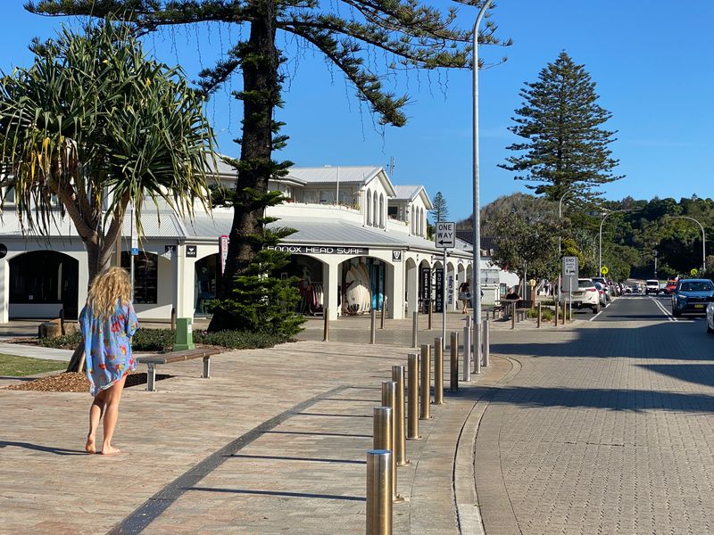 A woman walking through the village centre of Lennox Head