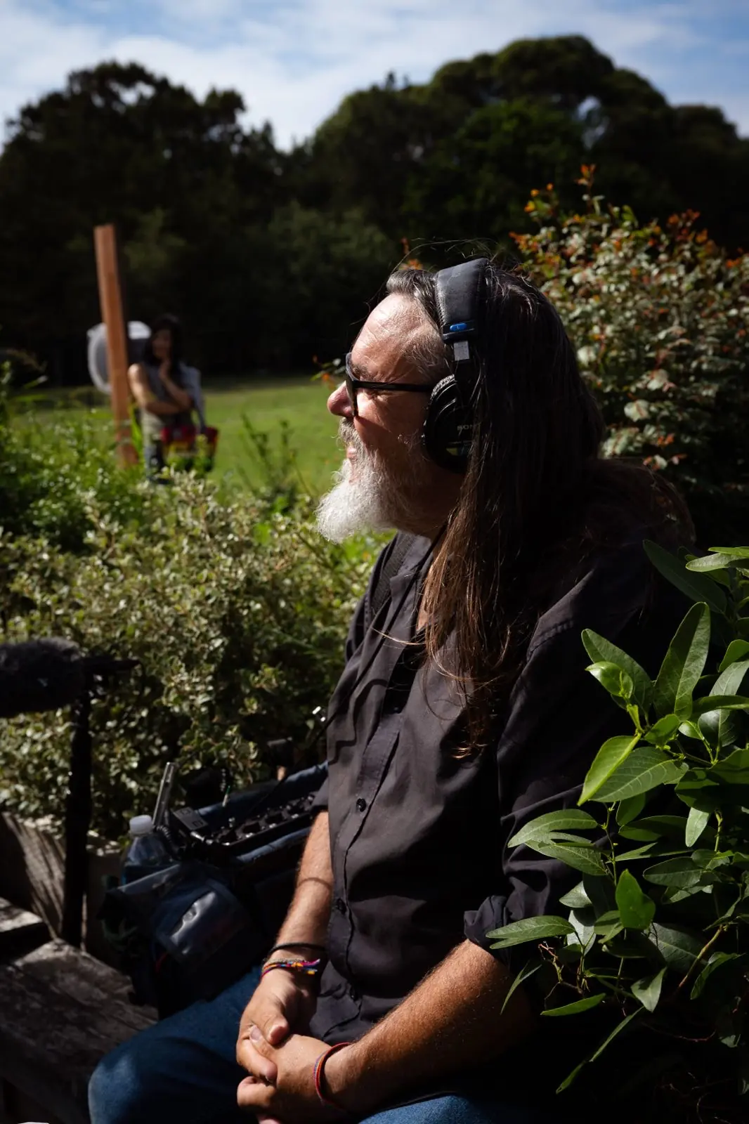 Rhys D. Webb working on location with sound bag and headphones