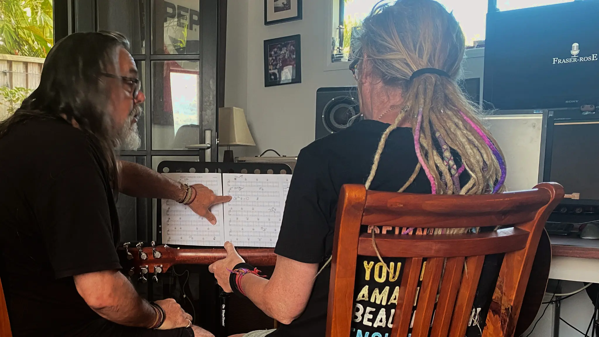 Rhys D. Webb discussing an arrangement with a musician in the studio